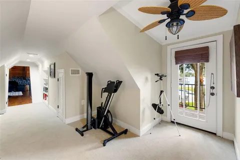 a view of a house with a yard and large tree