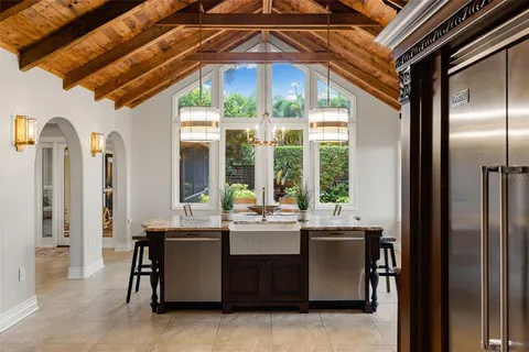 a living room with furniture a flat screen tv and a window