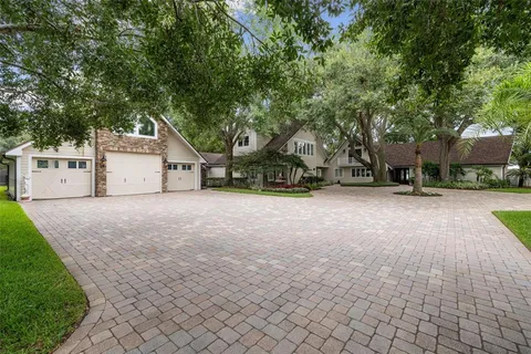 a living room with furniture floor to ceiling window and wooden floor