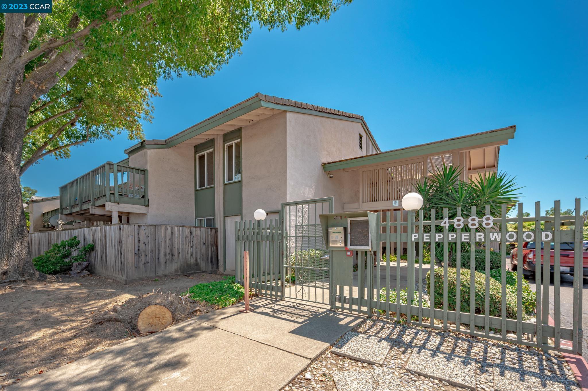 4888 Clayton Road, Unit 19 Concord, CA 94521 - Photo 1 of 1 a view of a house with a small yard and plants
