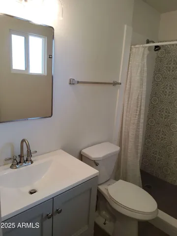 a white toilet sitting next to a bathroom sink