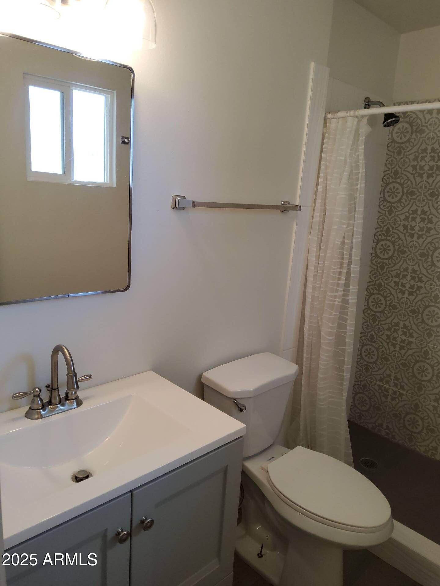 915 West 17th Place Tempe, AZ 85281 - Photo 11 of 13 a white toilet sitting next to a bathroom sink