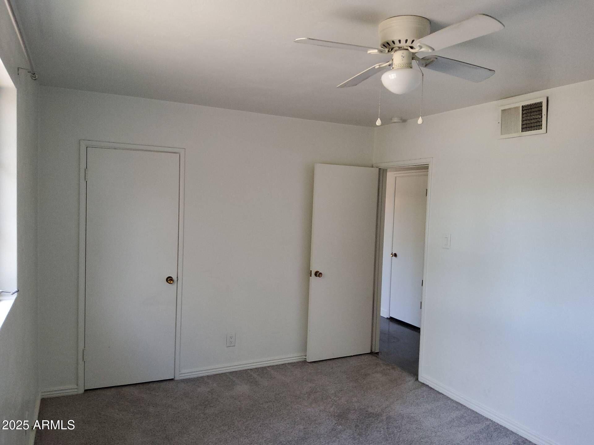 915 West 17th Place Tempe, AZ 85281 - Photo 2 of 13 an empty room with a ceiling fan and a window