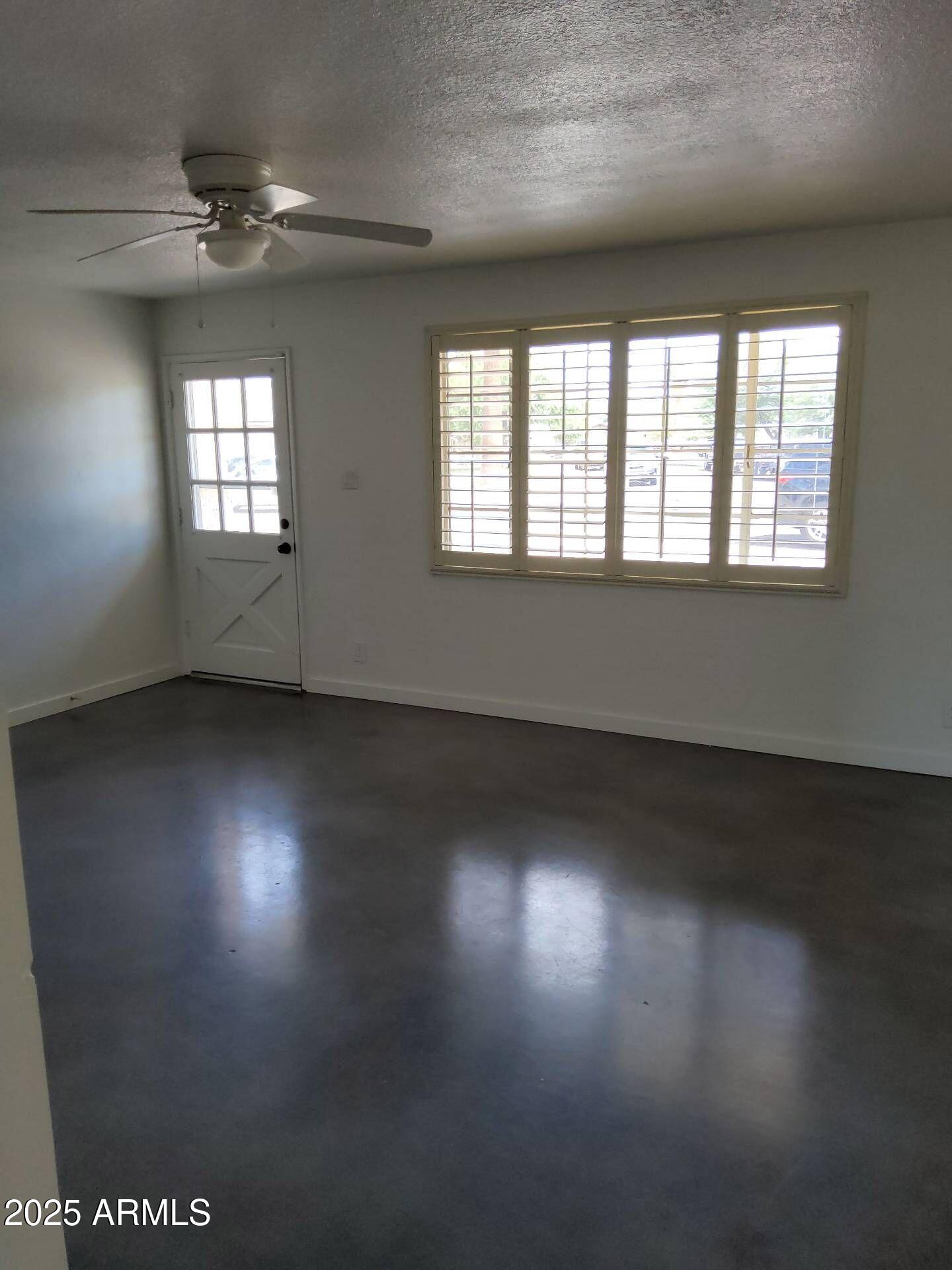 915 West 17th Place Tempe, AZ 85281 - Photo 6 of 13 an empty room with wooden floor and windows