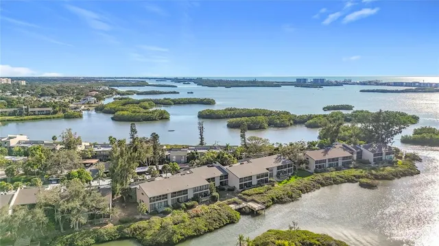 an aerial view of ocean with residential house with outdoor space and seating