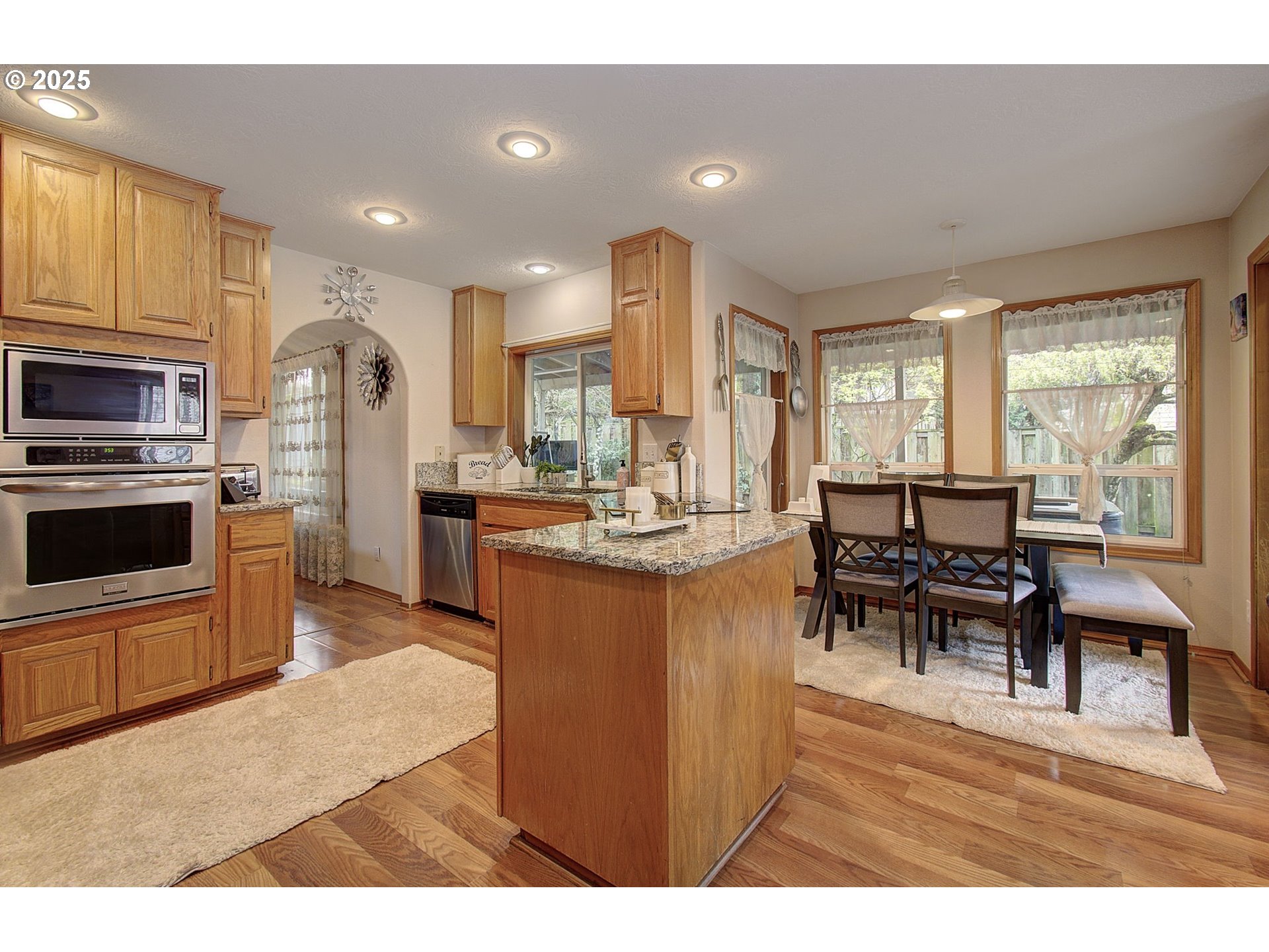 1758 Northwest 18th Court Gresham, OR 97030 - Photo 11 of 43 a living room with stainless steel appliances furniture a dining table and kitchen view