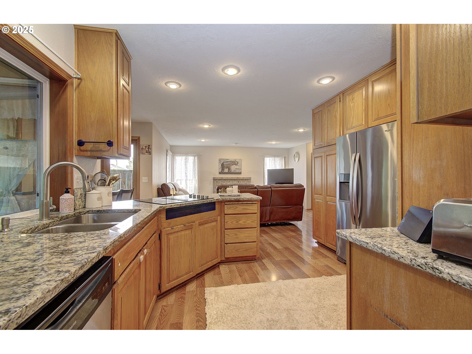 1758 Northwest 18th Court Gresham, OR 97030 - Photo 13 of 43 a kitchen with stainless steel appliances granite countertop a sink refrigerator and cabinets