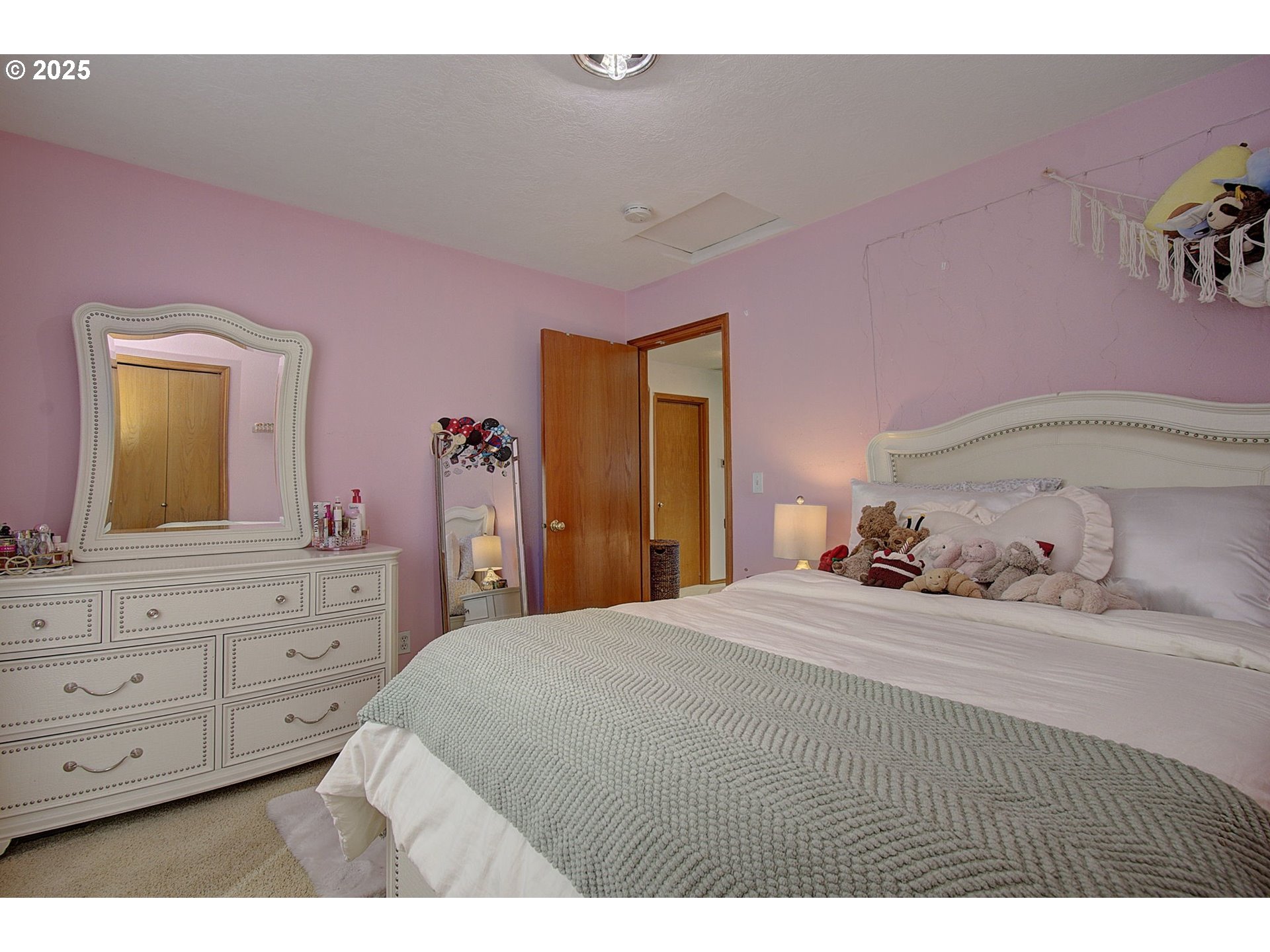 1758 Northwest 18th Court Gresham, OR 97030 - Photo 23 of 43 a bedroom with a bed and a dresser in it