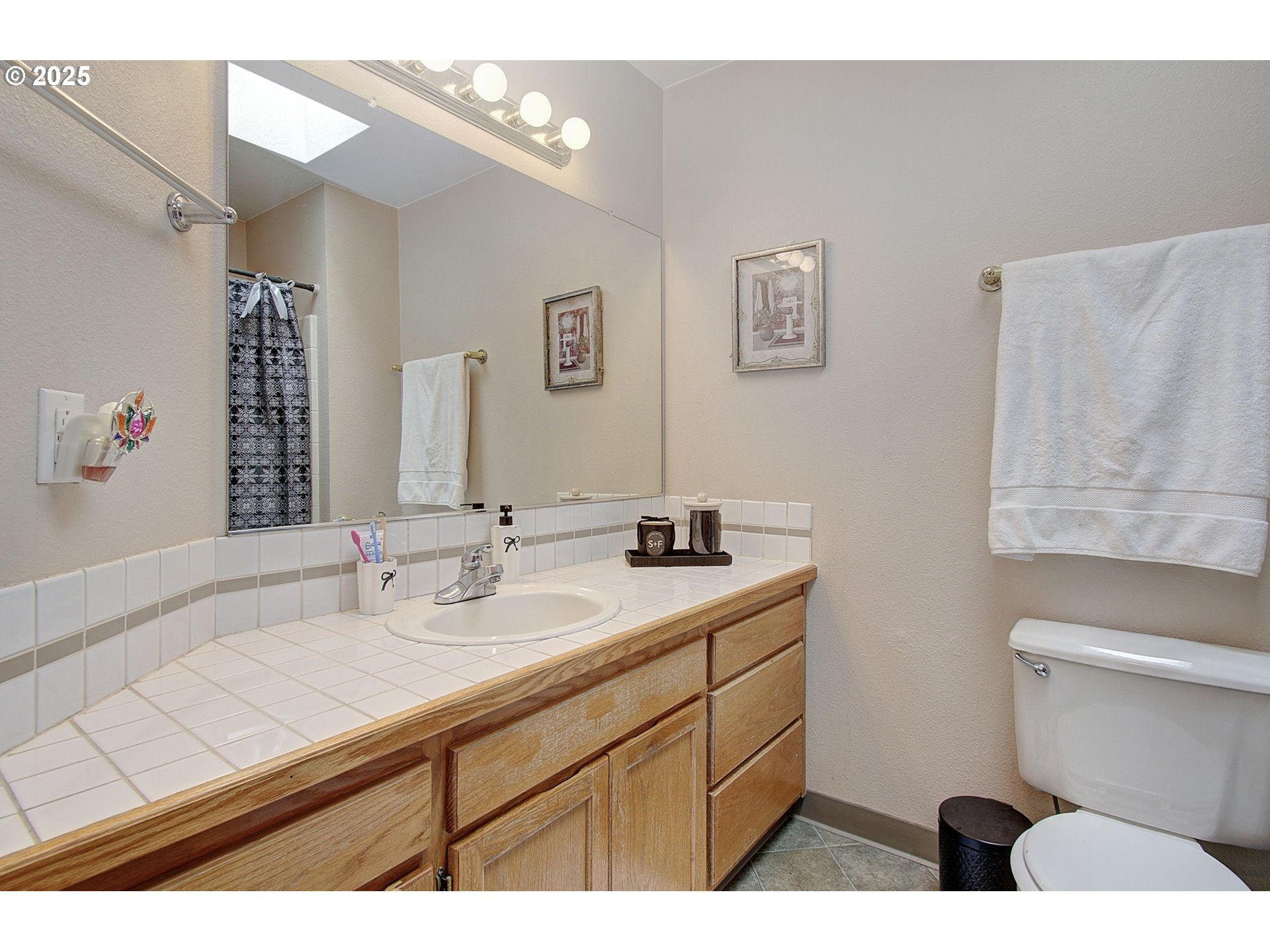 1758 Northwest 18th Court Gresham, OR 97030 - Photo 26 of 43 a bathroom with a sink mirror vanity and toilet