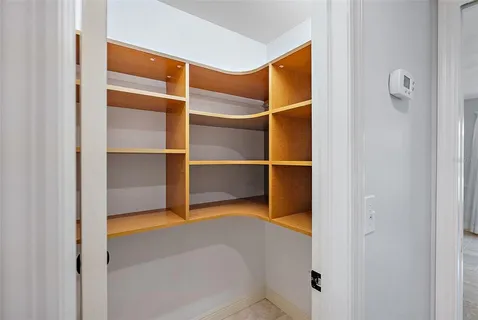 a view of an empty room with a fireplace and a floor to ceiling window