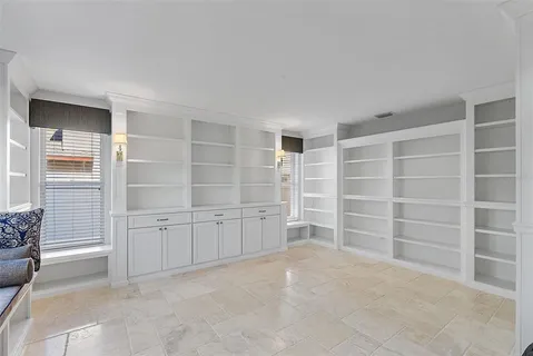 a large bedroom with a bed and a chandelier