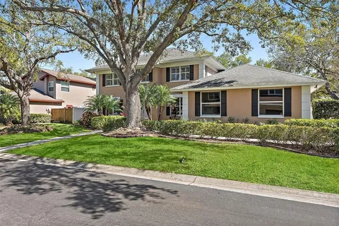 a front view of a house with a yard and trees