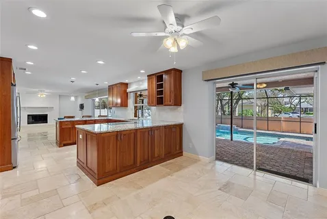 a large kitchen with stainless steel appliances granite countertop a stove and a large cabinets