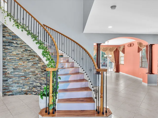a kitchen with stainless steel appliances kitchen island granite countertop a stove and a sink