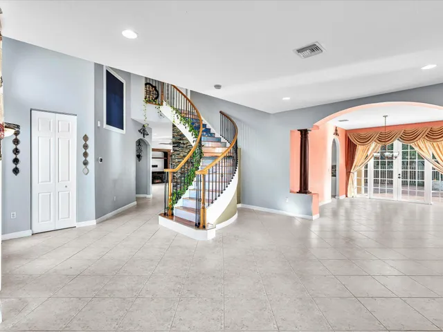 a kitchen with stainless steel appliances a dining table and chairs