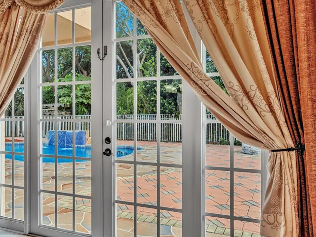 a view of a house with pool and sitting area