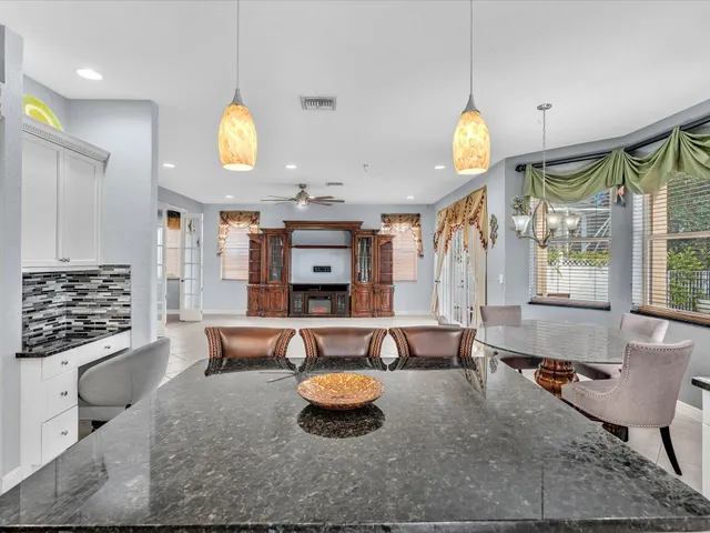 a bathroom with a double vanity sink mirror and bathtub
