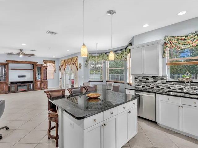 a view of a livingroom with a ceiling fan and window
