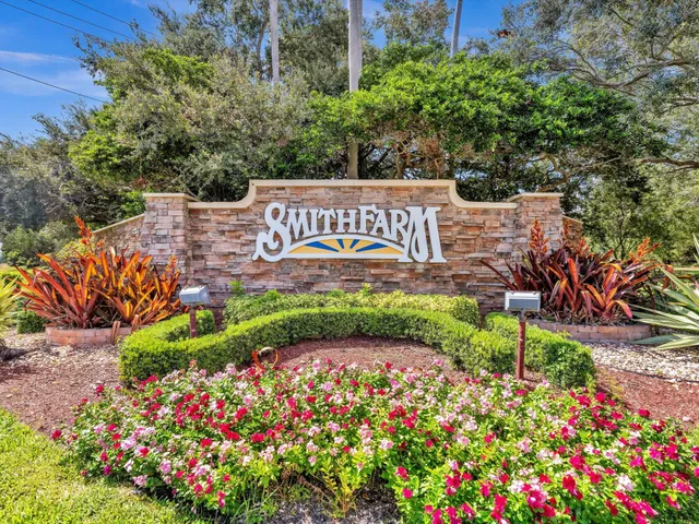 a view of a brick house with potted plants