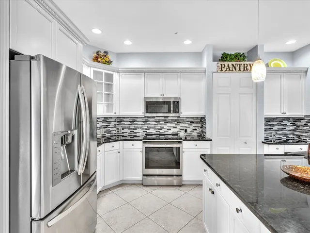 an aerial view of a house with a garden and trees