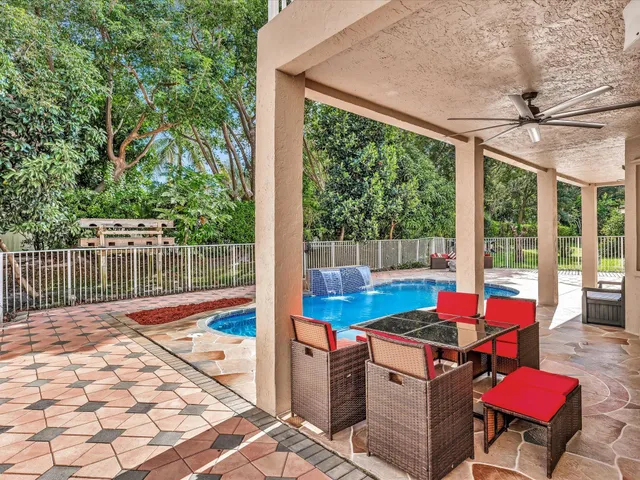 a view of a dining room with furniture large windows and wooden floor