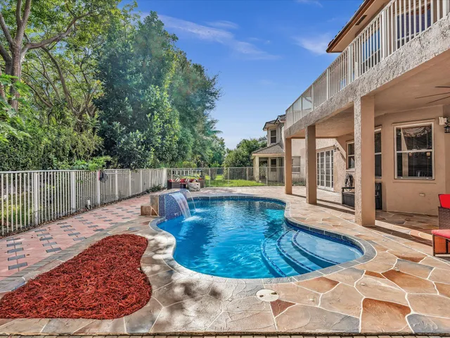 a view of a swimming pool with a yard