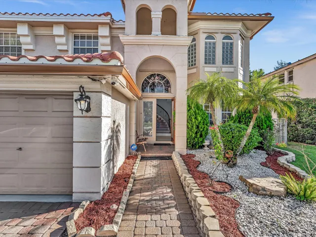 a view of staircase with wooden floor and a large window