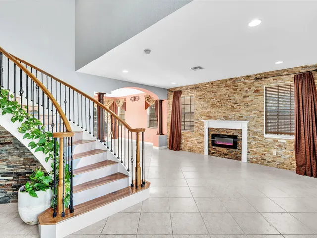 a living room with fireplace furniture and a flat screen tv