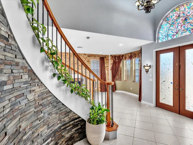 a view of a hallway with windows and stairs