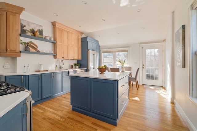 a kitchen with stainless steel appliances granite countertop a sink stove and wooden floor