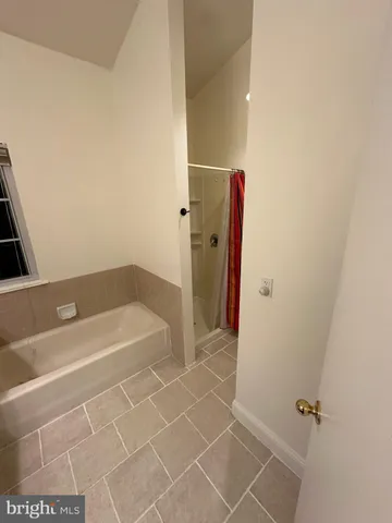 a bathroom with a bathtub and a shower