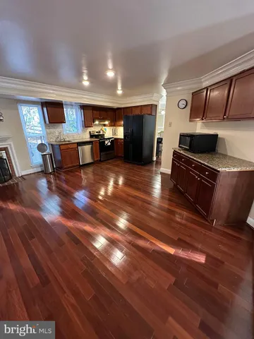 a view of kitchen with furniture and wooden floor