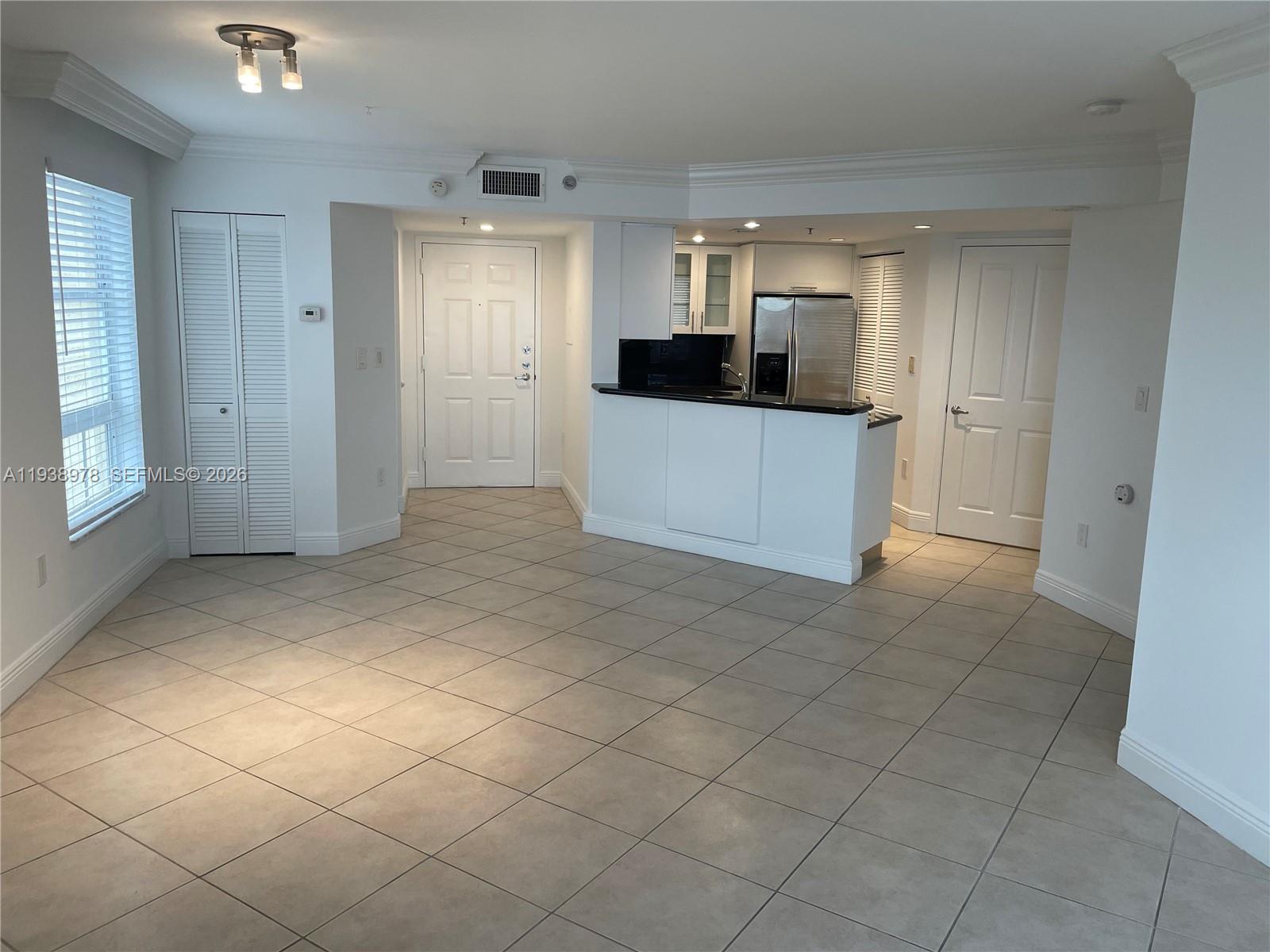 2351 Douglas Road, Unit 809 Miami, FL 33145 - Photo 9 of 14 a view of a kitchen with a sink and a refrigerator