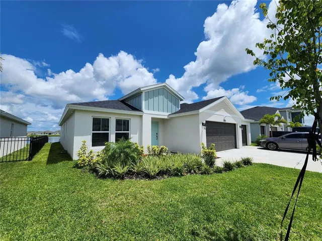 a front view of house with yard and trees around