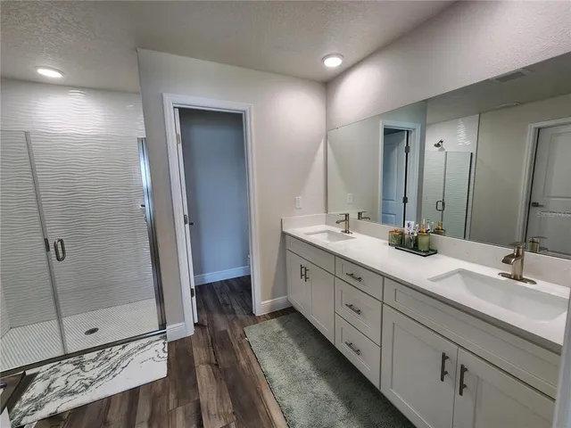 a bathroom with double sink and a mirror