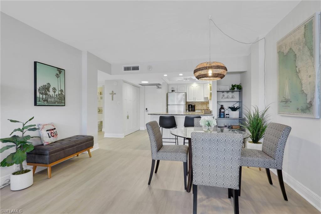 1 Bluebill Avenue, Unit 401 Naples, FL 34108 - Photo 11 of 35 a living room with furniture and a table
