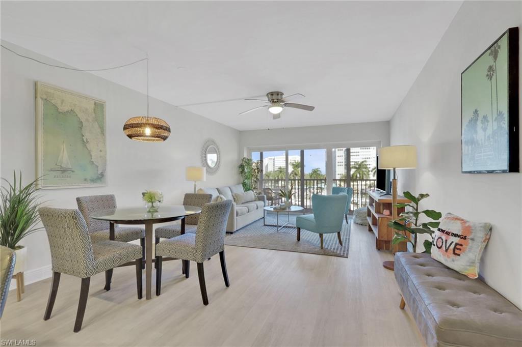 1 Bluebill Avenue, Unit 401 Naples, FL 34108 - Photo 12 of 35 a view of a dining room with furniture window and outside view