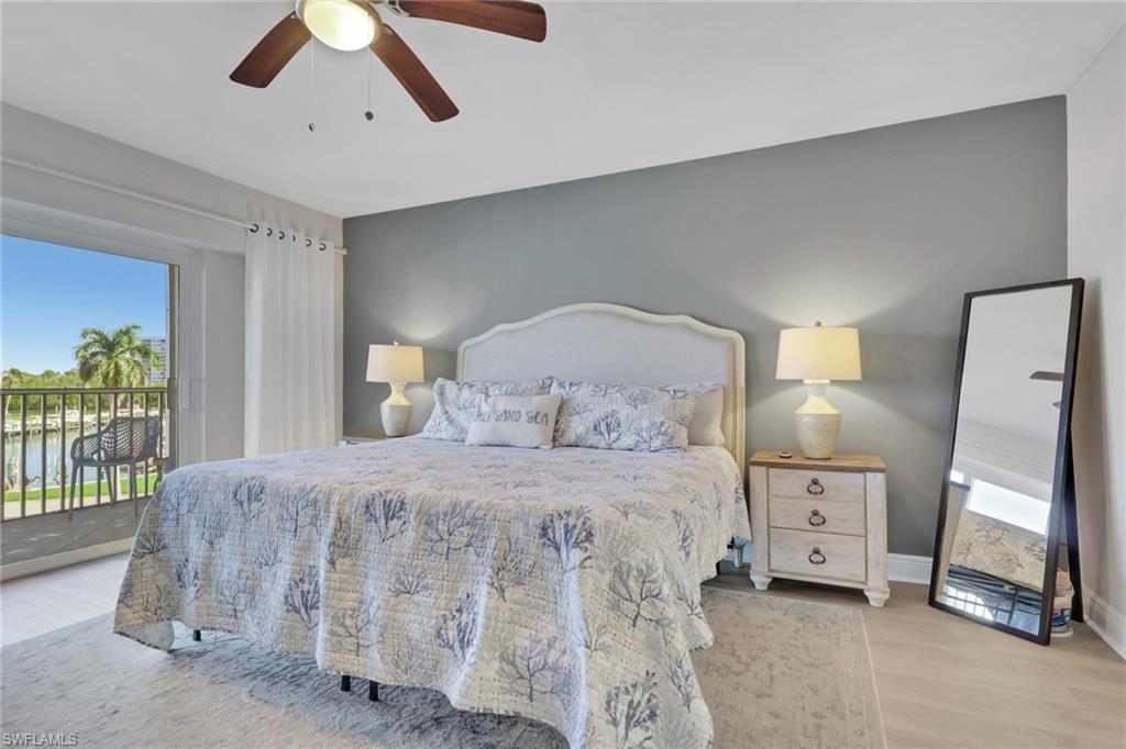 1 Bluebill Avenue, Unit 401 Naples, FL 34108 - Photo 17 of 35 a bedroom with a bed and a window