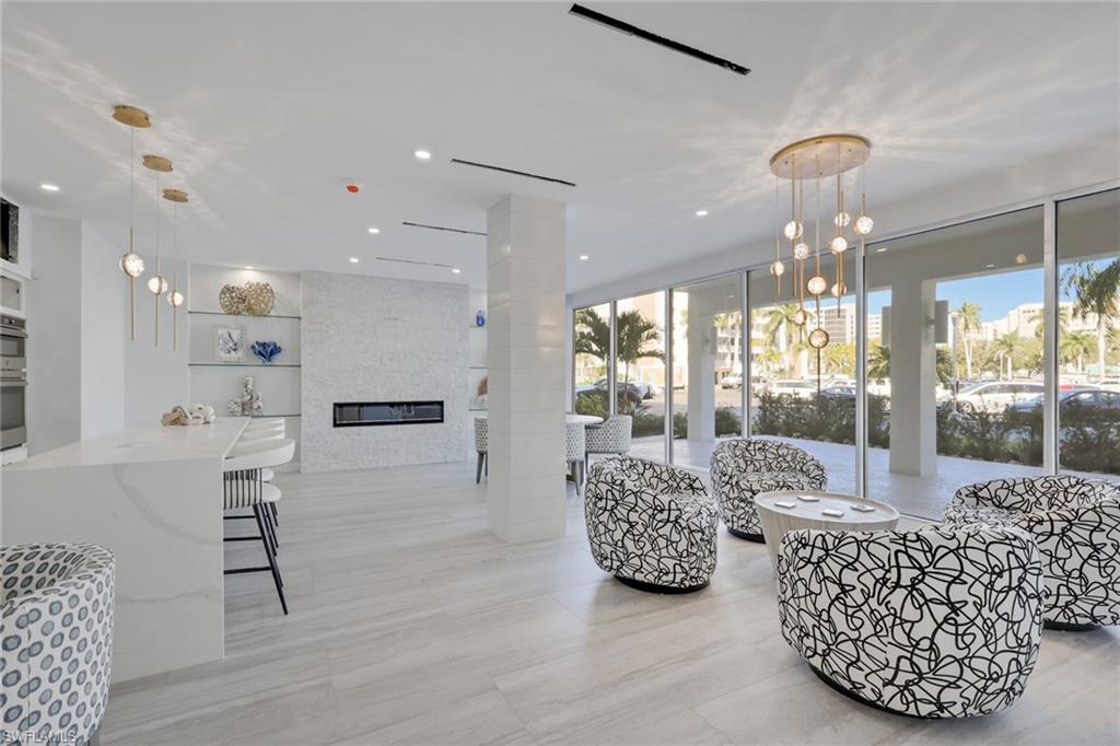 1 Bluebill Avenue, Unit 401 Naples, FL 34108 - Photo 5 of 35 a living room with furniture and a large window