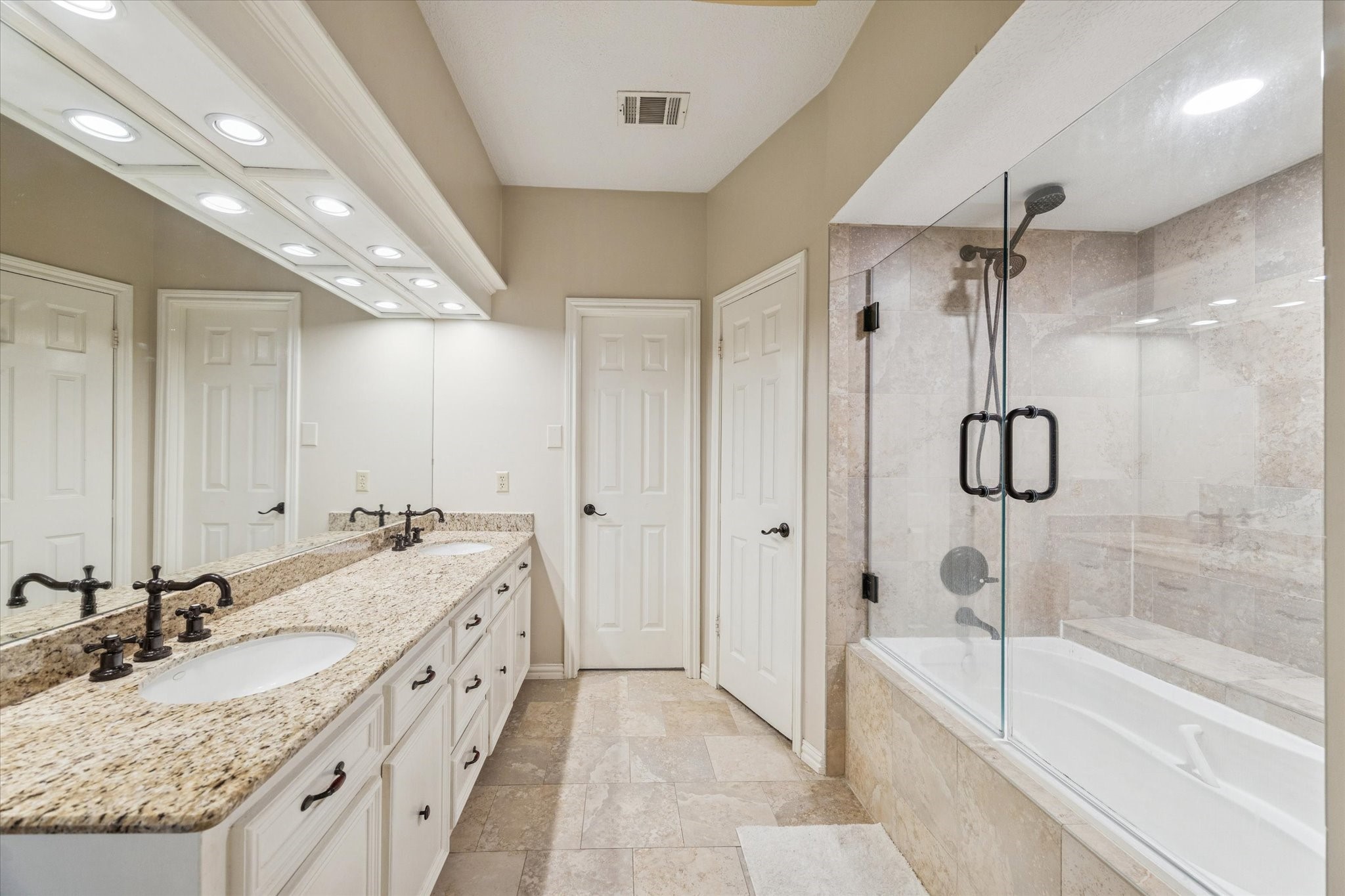 18327 Forest Elms Drive Spring, TX 77388 - Photo 18 of 30 a spacious bathroom with a granite countertop sink a mirror a bathtub and shower
