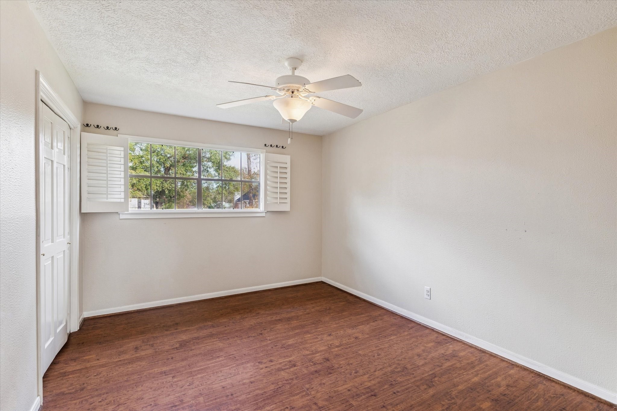 18327 Forest Elms Drive Spring, TX 77388 - Photo 22 of 30 an empty room with windows and fan