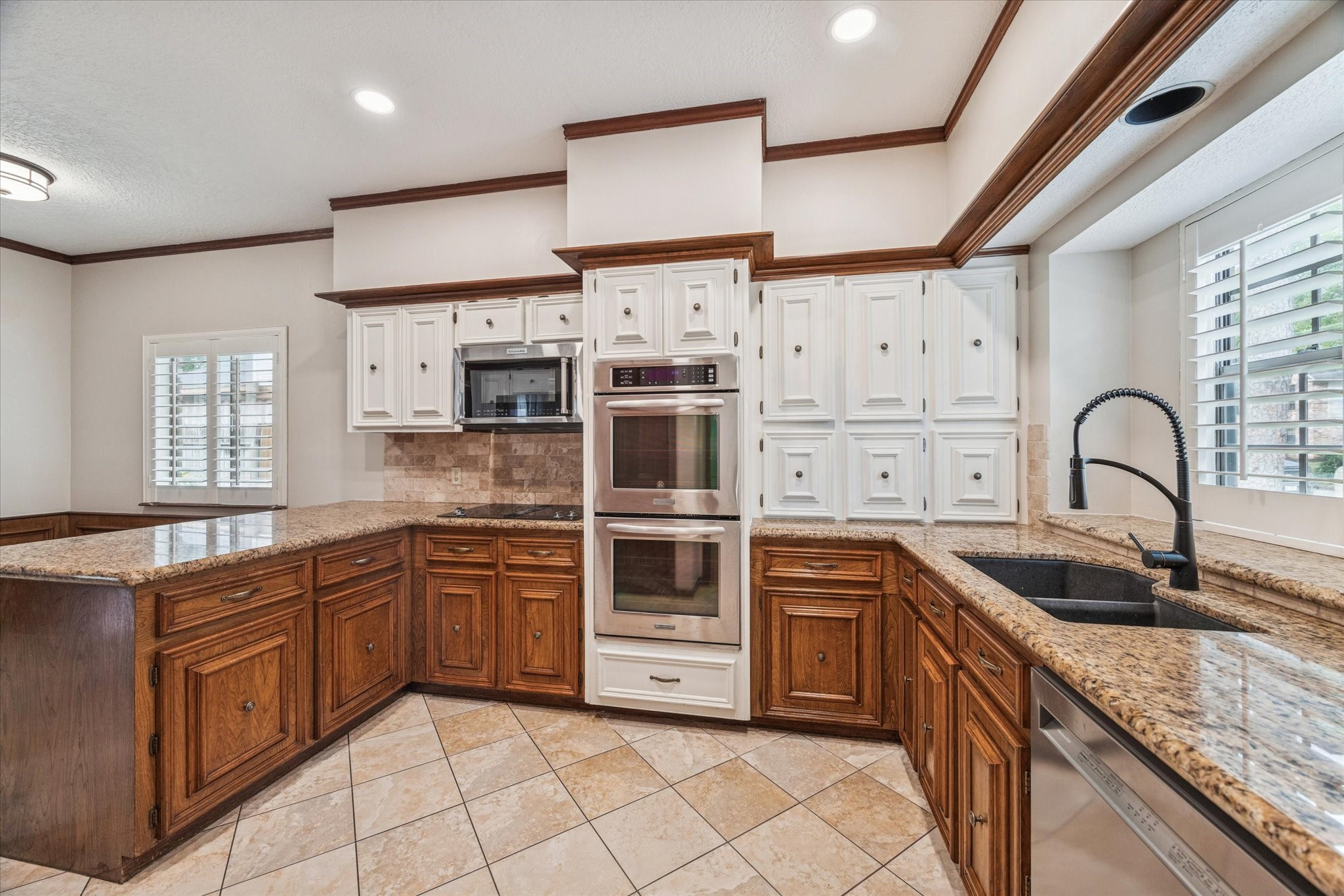 18327 Forest Elms Drive Spring, TX 77388 - Photo 9 of 30 a kitchen with stainless steel appliances granite countertop a stove and a sink