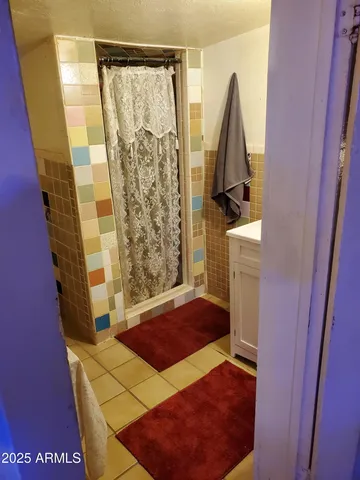 a bedroom with a bed and a mirror