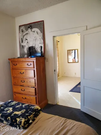 a bedroom with a bed and a mirror