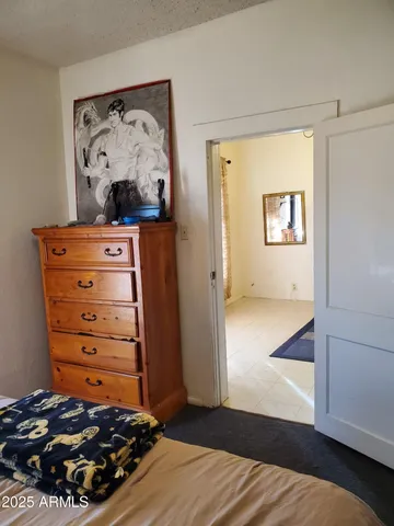 a bedroom with a bed and a mirror