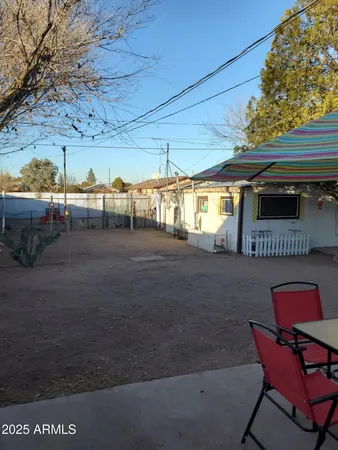 a backyard of a house with yard and outdoor seating