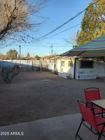 a backyard of a house with yard and outdoor seating