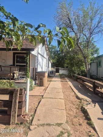 a view of a backyard both side of the house