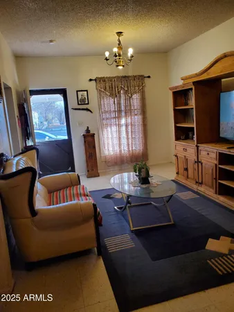a living room with furniture and a chandelier
