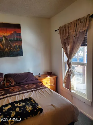 a bedroom with a bed and a window